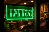 Neon green 'TATTOO' sign in a tattoo parlor