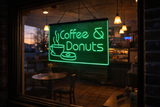 Neon sign advertising coffee and donuts inside a cafe.