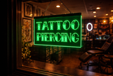 Neon sign reading 'Tattoo Piercing' in a tattoo parlor.