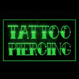 Green Tattoo and Piercing LED sign with engraved lettering glowing on acrylic panel, tattoo parlor window display light.
